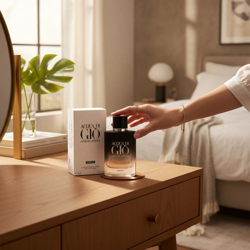 AuraGlow presents Acqua Di Gio Parfum by Giorgio Armani in a sleek black gradient bottle with its white box on a desk.