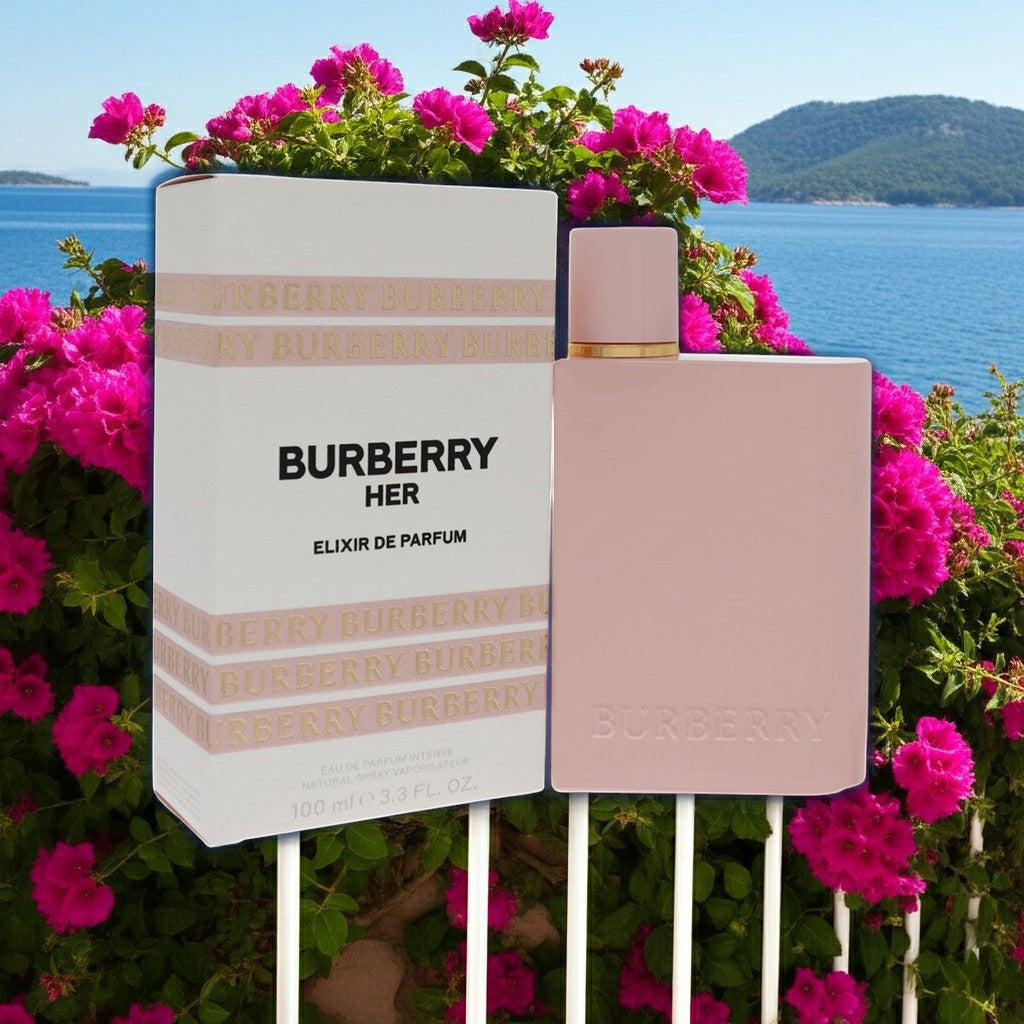 AuraGlow Burberry Her Elixir Eau de Parfum Intense bottle and box against a backdrop of pink flowers and blue sea.