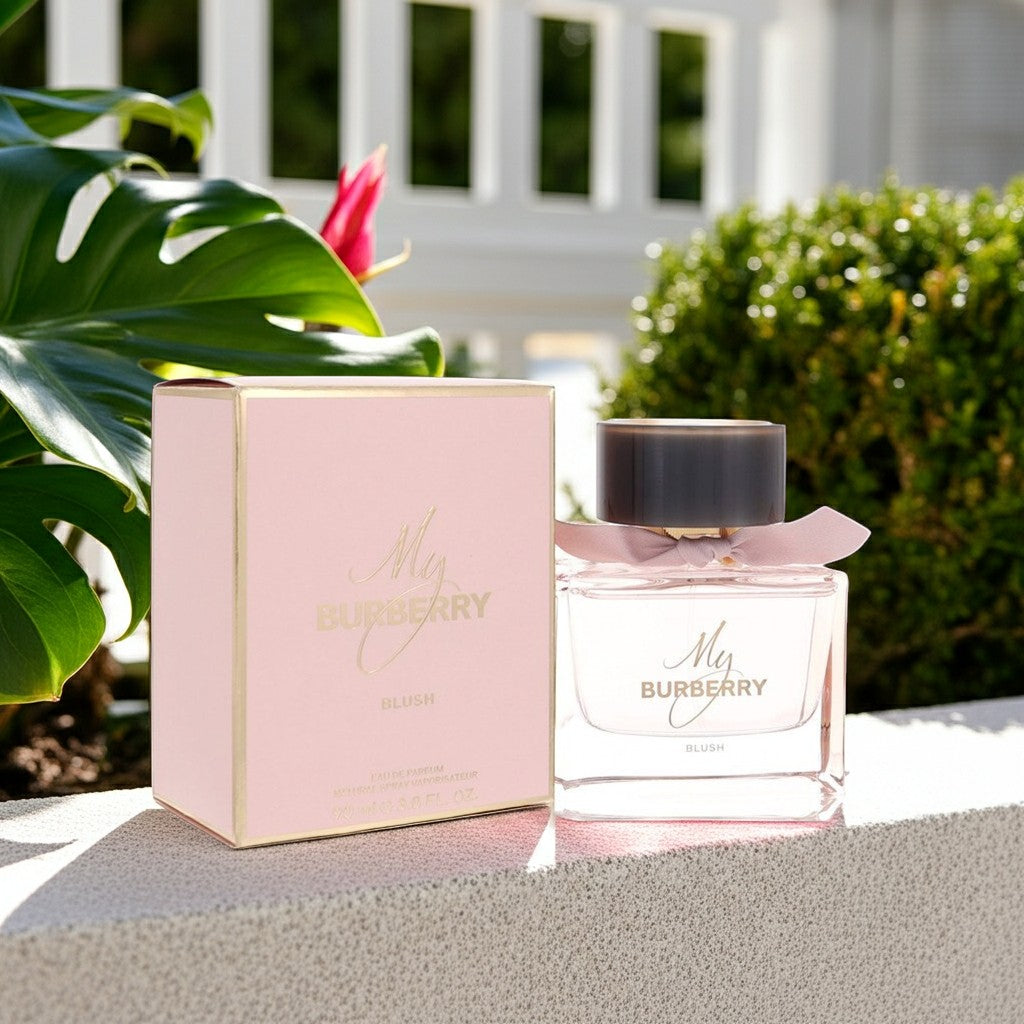 AuraGlow Burberry My Burberry Blush eau de parfum bottle and pink box set outdoors with lush green foliage.