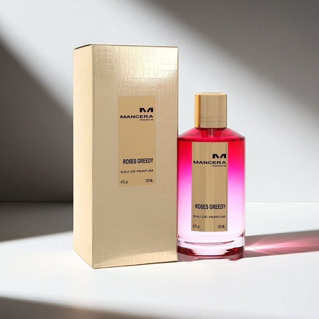 AuraGlow Mancera Roses Greedy unisex eau de parfum bottle and gold box on a white surface with soft lighting.