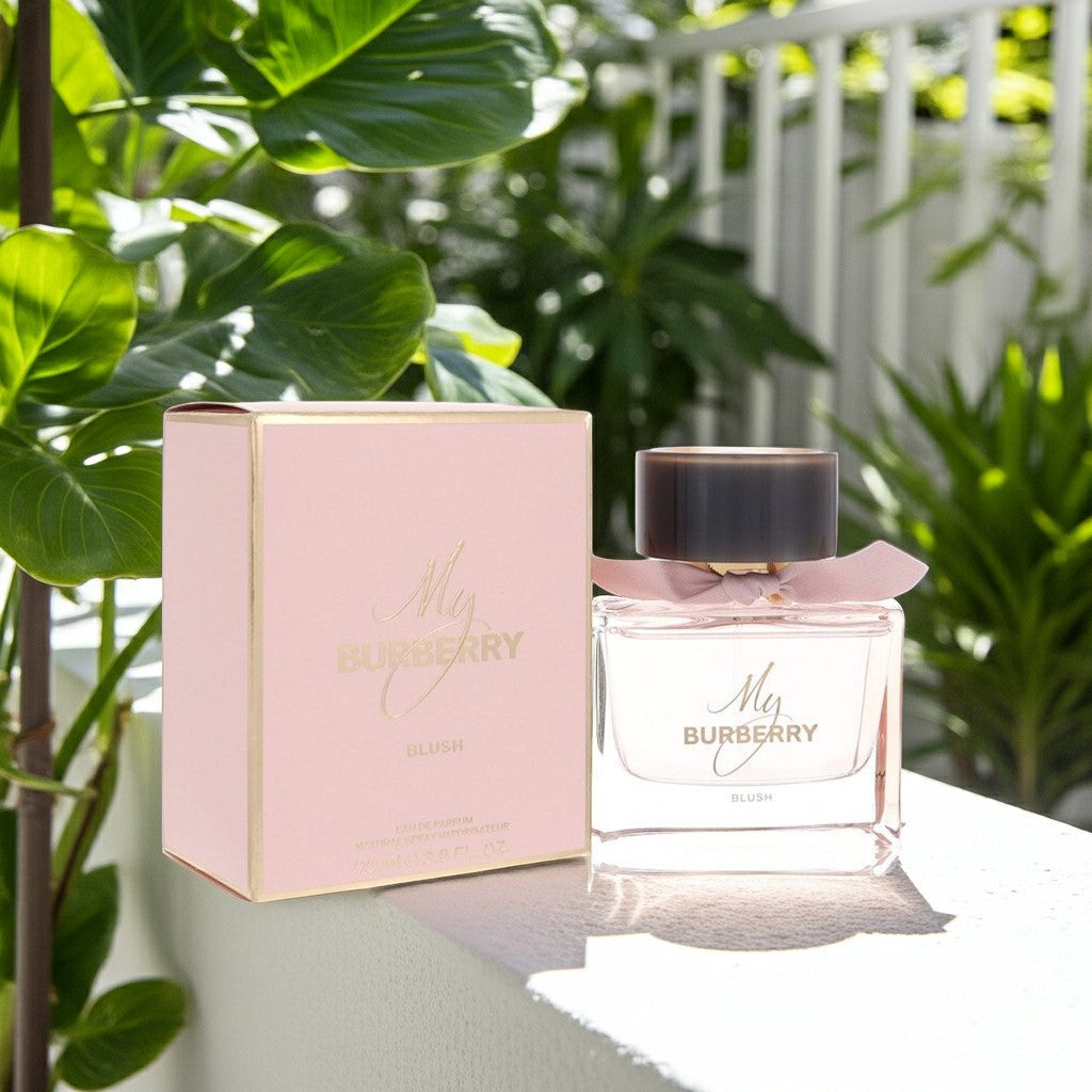 AuraGlow My Burberry Blush eau de parfum bottle and pink box set outdoors surrounded by lush green tropical plants