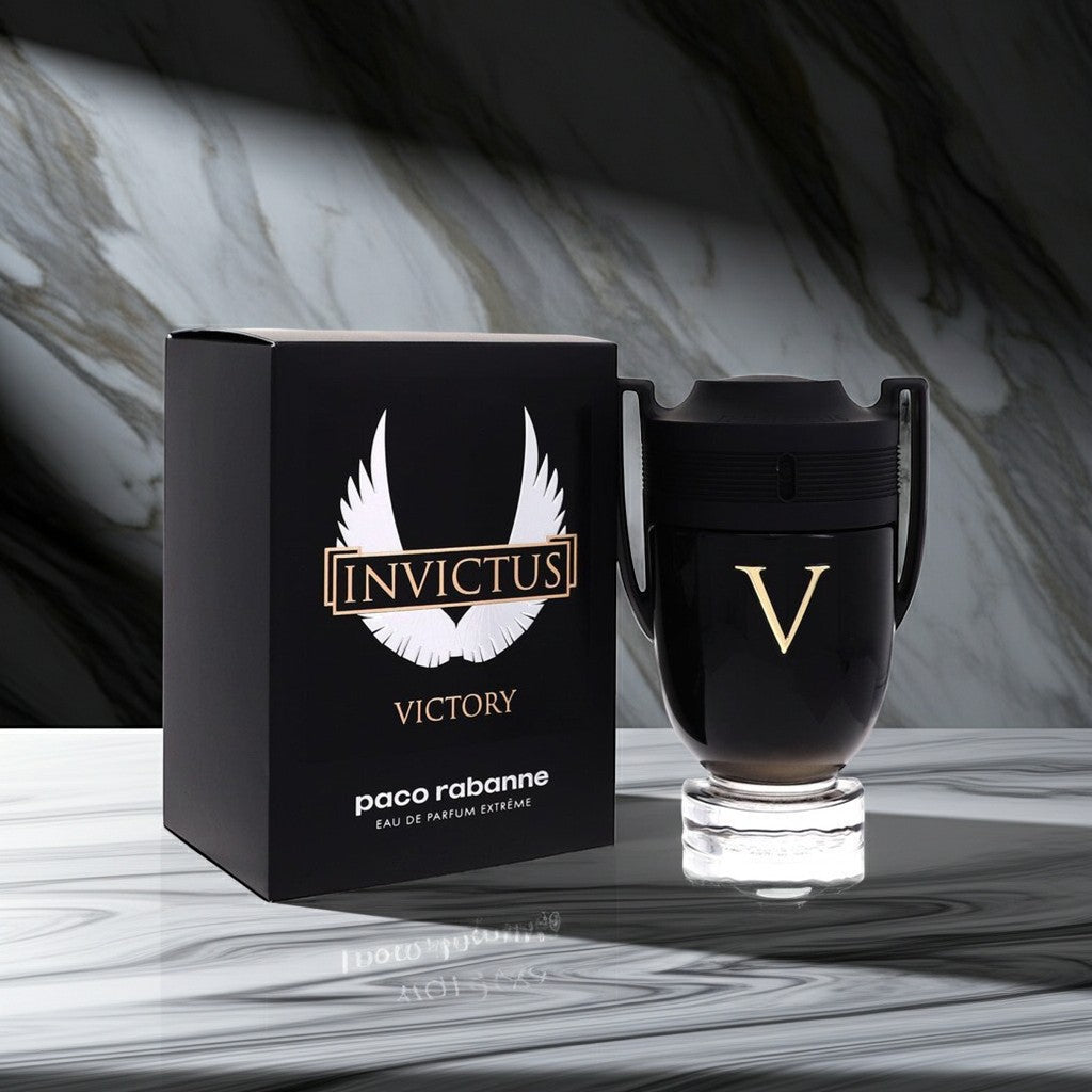 AuraGlow Paco Rabanne Invictus Victory Eau de Parfum Extreme bottle and black box on a marble surface.