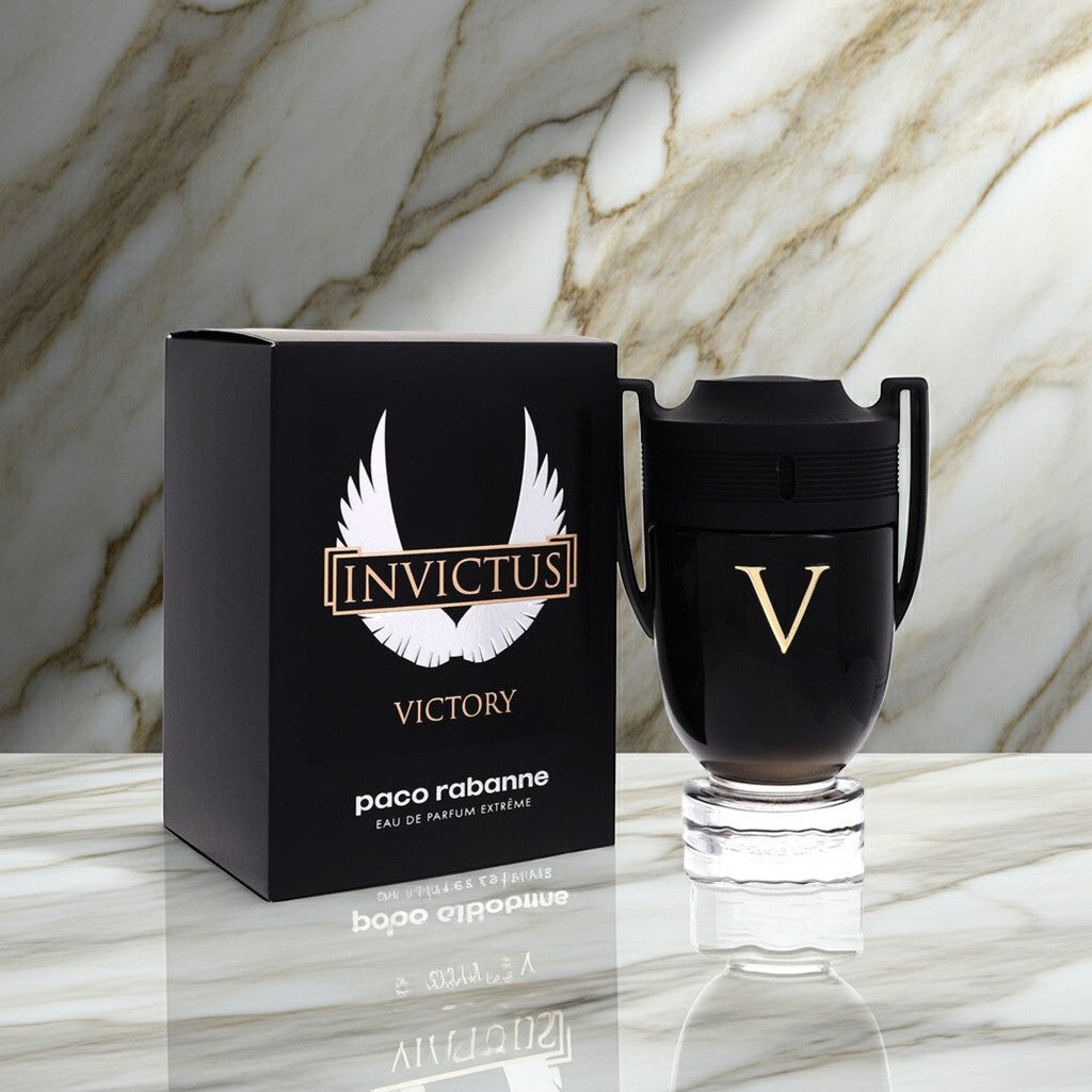 AuraGlow Paco Rabanne Invictus Victory Eau de Parfum Extreme bottle and black box on a marble surface.
