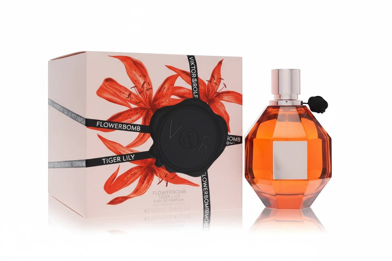 AuraGlow Viktor&Rolf Flowerbomb Tiger Lily perfume bottle with amber liquid next to its floral-patterned box.